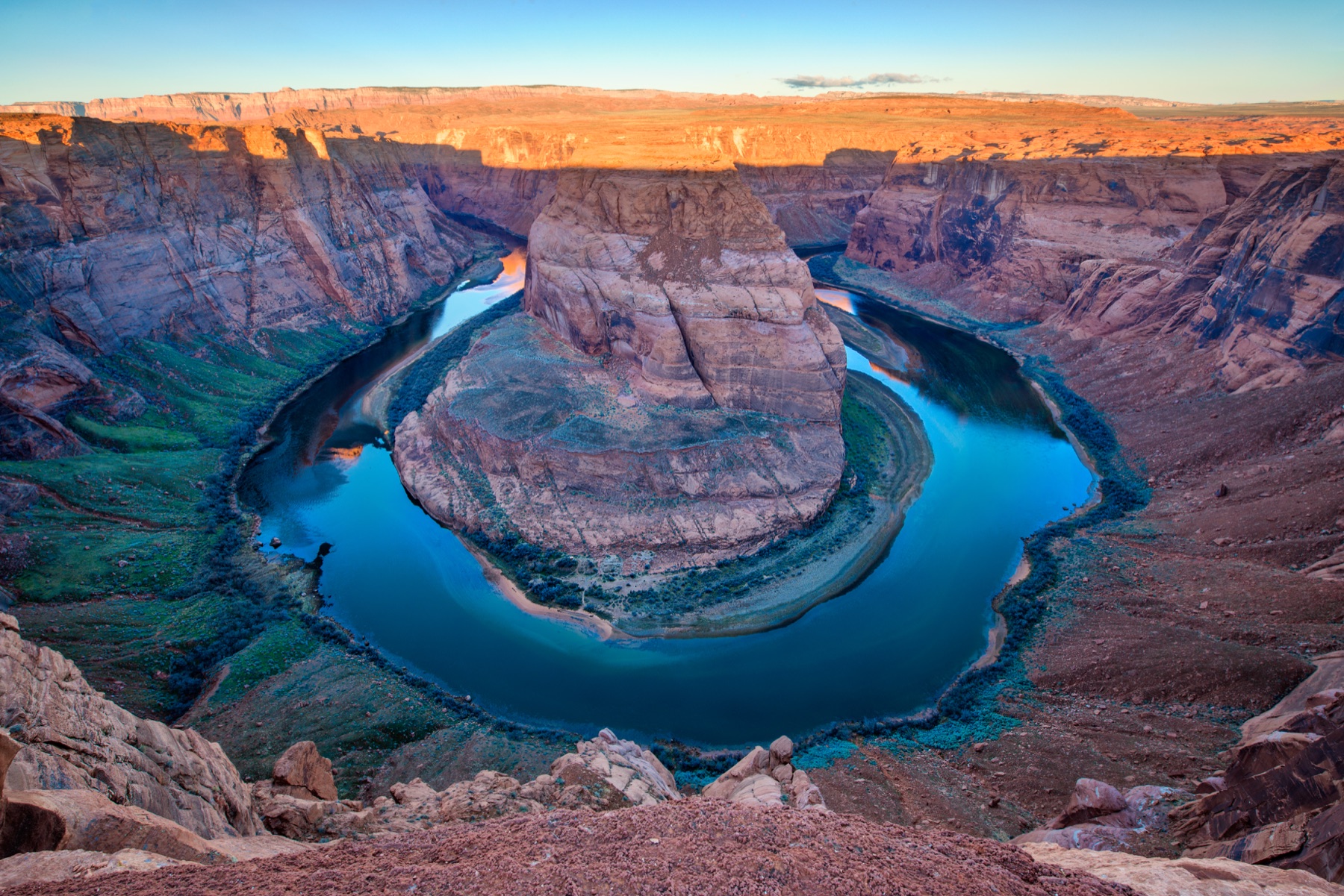 The Colorado River curving around Horseshoe Bend beneath layered canyon walls